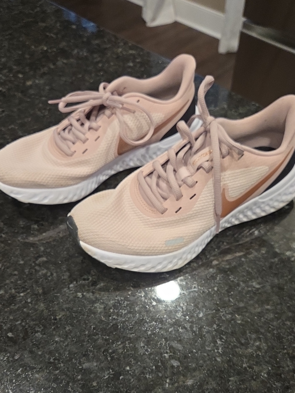 Nike Revolution Women’s Blush Pink Athletic Running Shoes with Rose-Gold Swoosh.